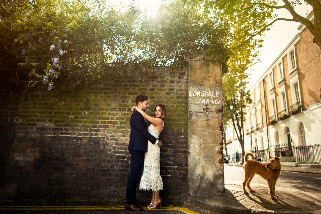 wedding portrait of couple and passing dog
