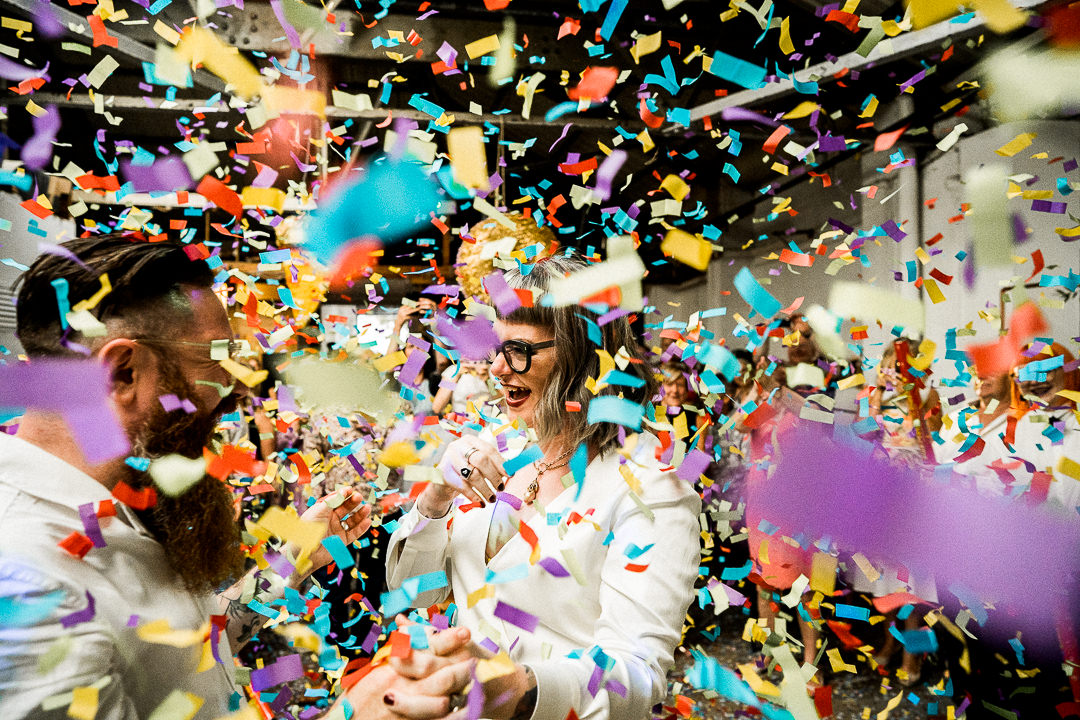 a wedding couple are covered in confetti shot by canons during their first dance at the old dairy in hackney 