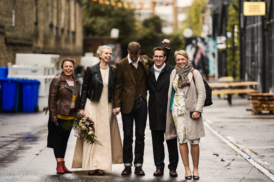 a joyous group shot after a Covid restricted wedding in hackney East London