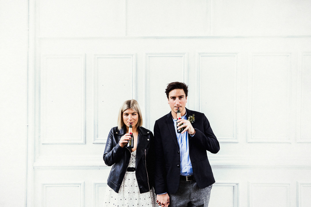 a couple celebrate with champagne after their wedding at Islington Town Hall