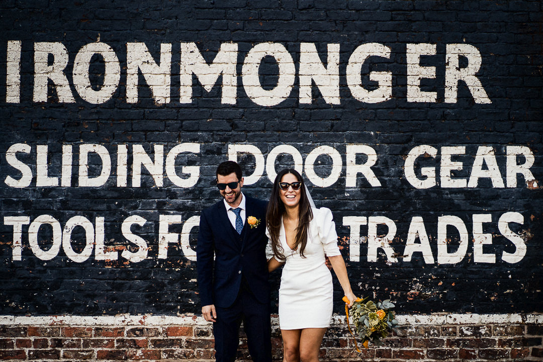 a wedding couple stood in front of a painted wall in the centre of York
