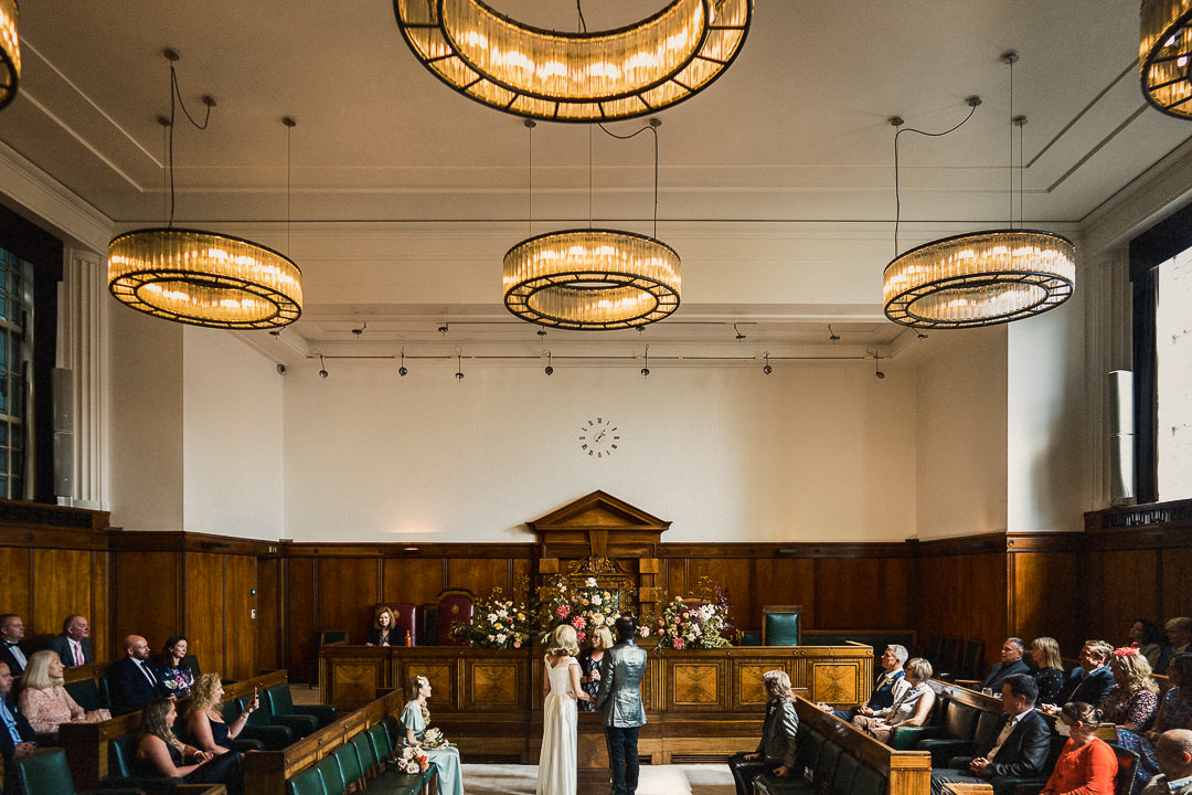 a wide shot of a ceremony in the council chamber at The Town Hall Hotel in London