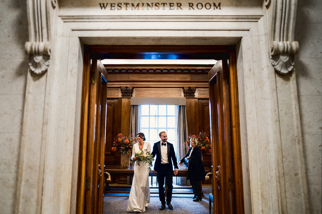 a married couple exit the Westminster room at Marylebone Town Hall