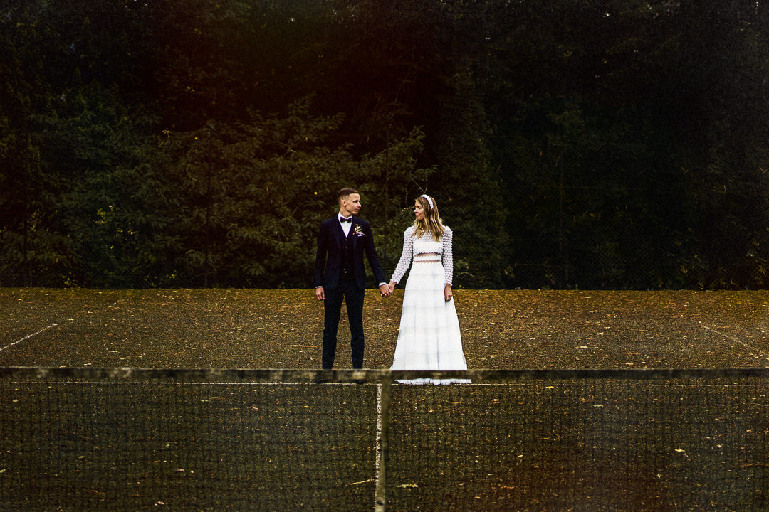 a wedding portrait shot on a tennis court at Plas Dinam country house